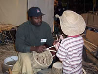 Robert Watson explains white oak basketry to a young child.